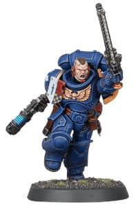 Futuristic warrior in full armour in 1/64 scale - Assault Intercessor Sergeant #1 build #1 in Mk10 Tacticus armour without helmet, with plasma pistol and Astartes chainsword from Indomitus set for Warhammer 40,000 Ed9 from Games Workshop, 2020 - Miniature figure review